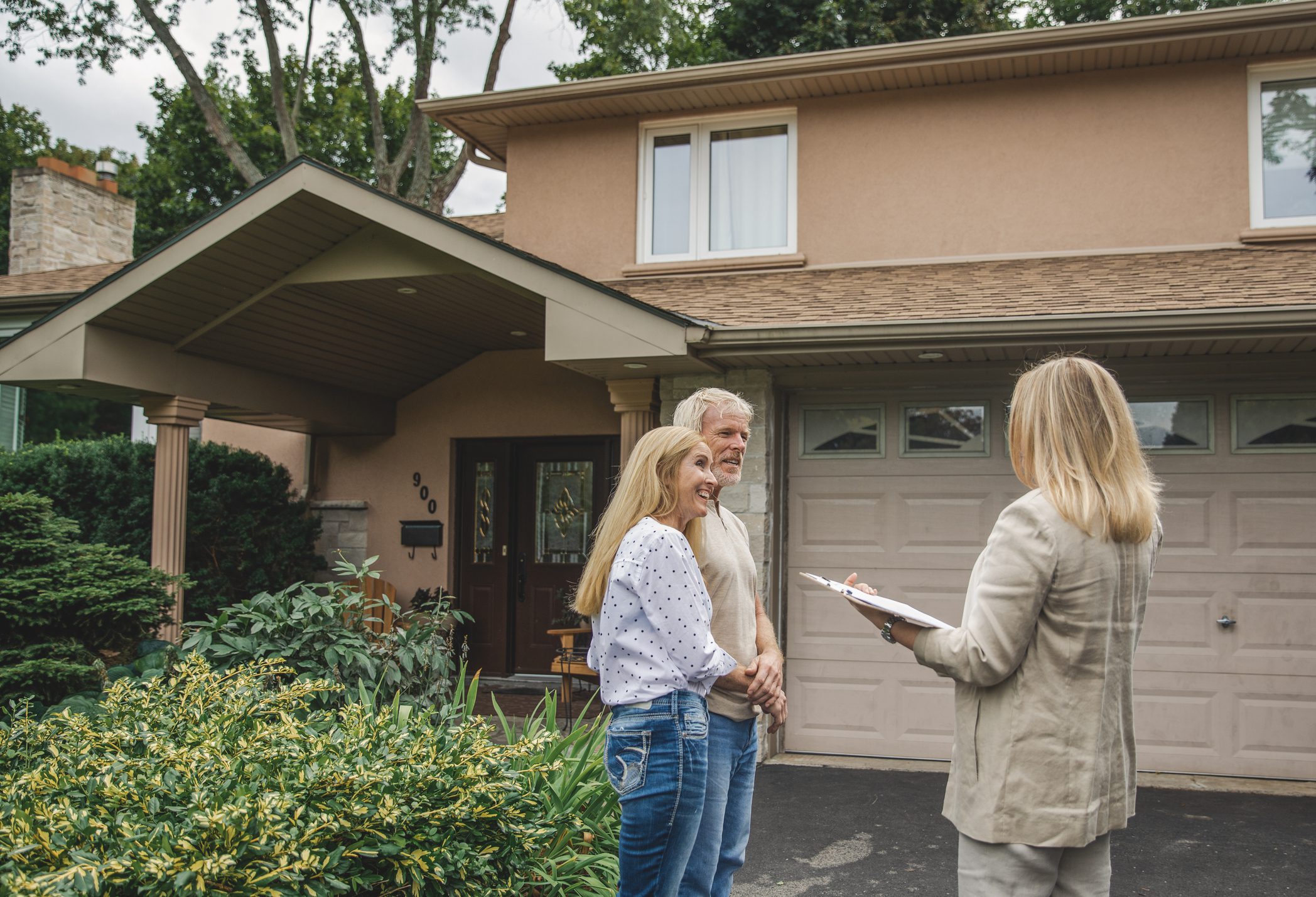 Homebuyers discussing property with agent